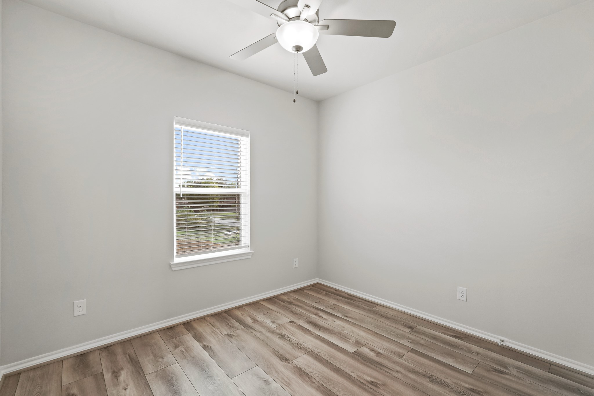 1407 Acorn Meadow Street Houston, TX 77067 - Photo 14 of 22 wooden floor in an empty room with a window