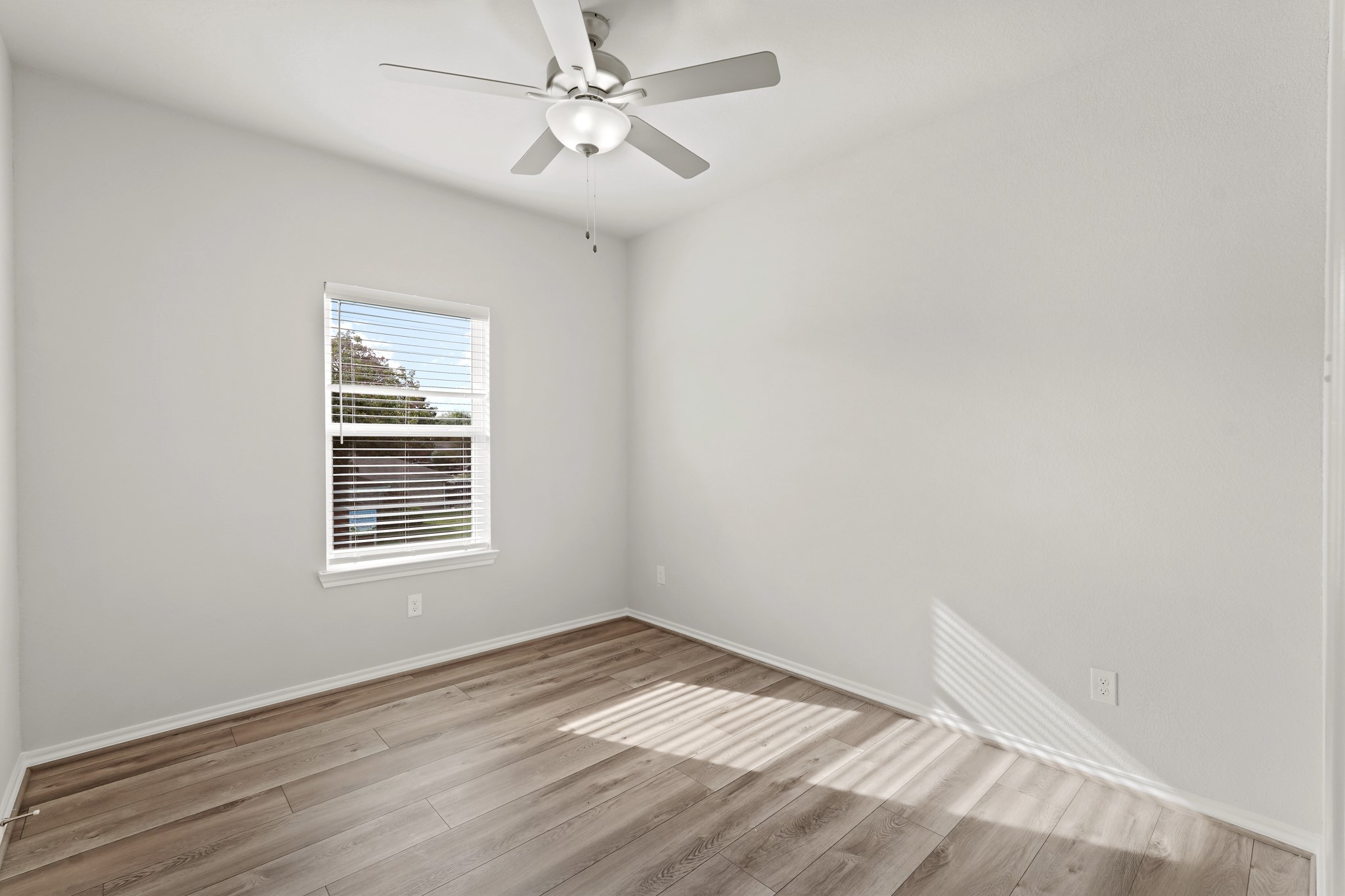1407 Acorn Meadow Street Houston, TX 77067 - Photo 15 of 22 an empty room with a window and a ceiling fan