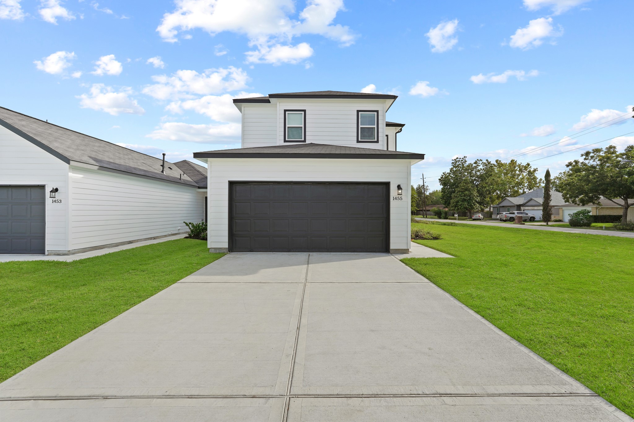 1407 Acorn Meadow Street Houston, TX 77067 - Photo 2 of 22 a front view of a house with a yard and garage
