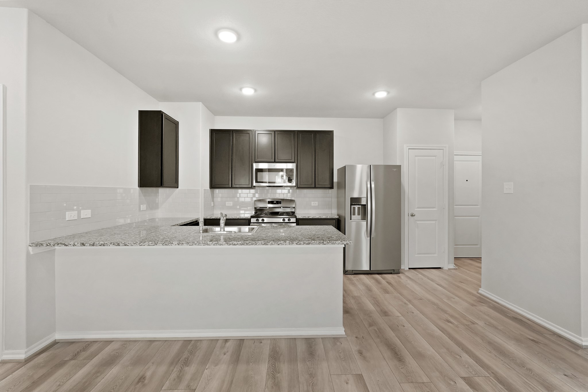 1407 Acorn Meadow Street Houston, TX 77067 - Photo 4 of 22 a kitchen with stainless steel appliances granite countertop a refrigerator a stove top oven a sink and dishwasher