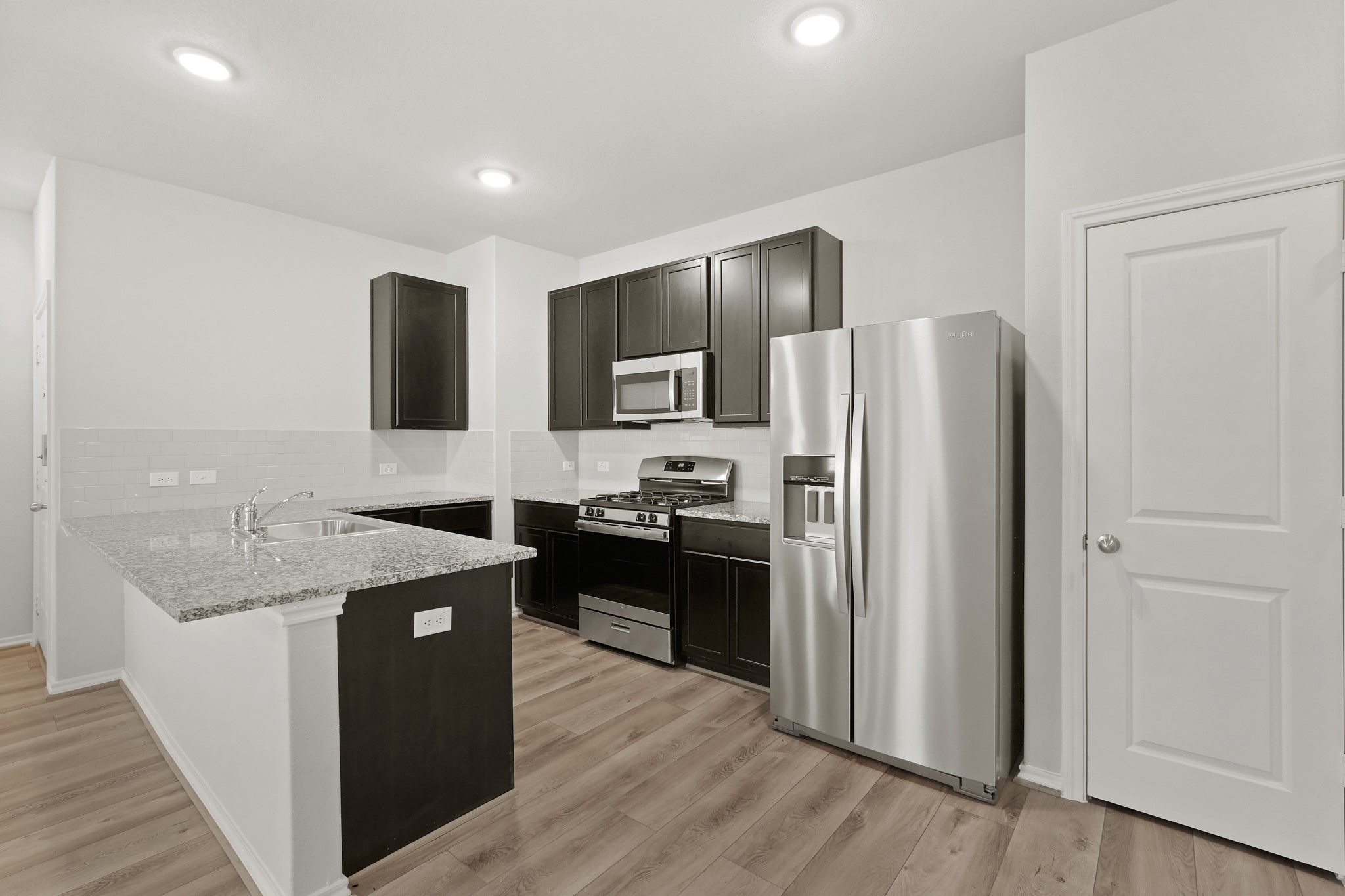 1407 Acorn Meadow Street Houston, TX 77067 - Photo 5 of 22 a kitchen with stainless steel appliances granite countertop a refrigerator a sink a stove and oven