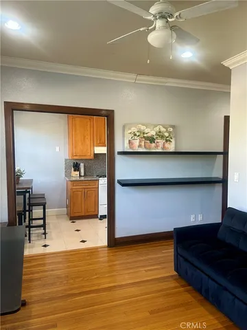 a living room filled with furniture window and hardwood floor