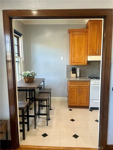 a kitchen with a sink stove and cabinets