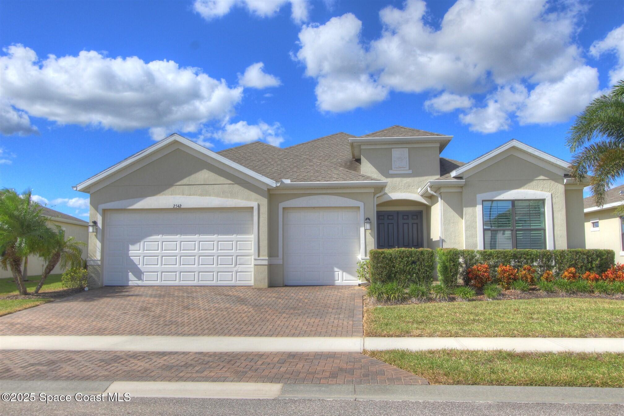 2542 Chapel Bridge Lane Melbourne, FL 32940 - Photo 1 of 44 a front view of a house with a yard
