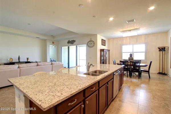 a kitchen with center island table and chairs