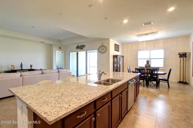 a kitchen with center island table and chairs