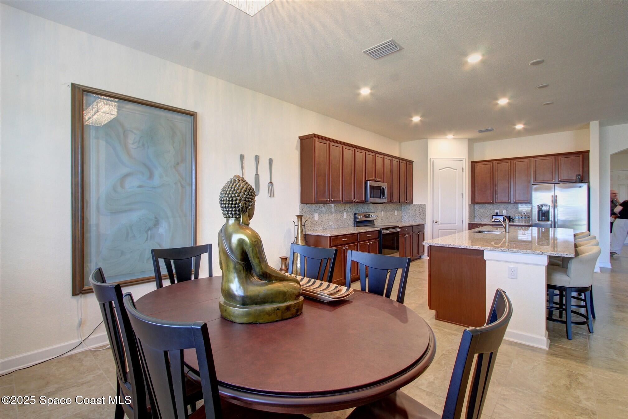 2542 Chapel Bridge Lane Melbourne, FL 32940 - Photo 17 of 44 a view of a dining room with furniture