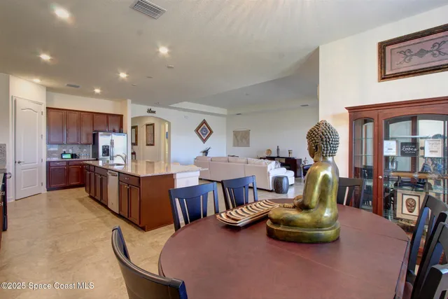 a living room with lots of furniture and kitchen view