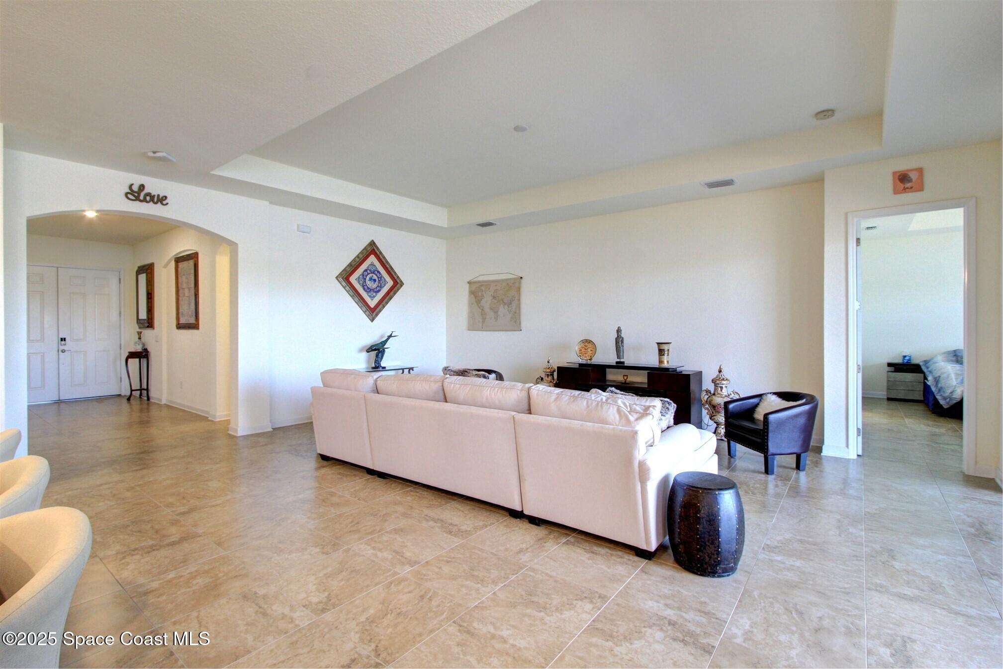 2542 Chapel Bridge Lane Melbourne, FL 32940 - Photo 19 of 44 a living room with furniture and a flat screen tv