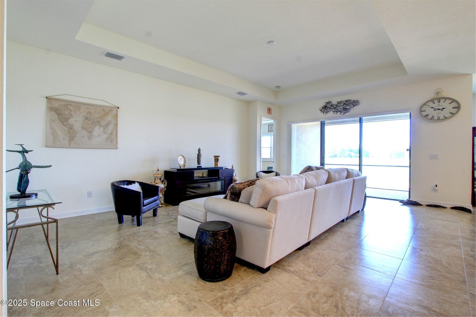 2542 Chapel Bridge Lane Melbourne, FL 32940 - Photo 20 of 44 a living room with furniture and a large window