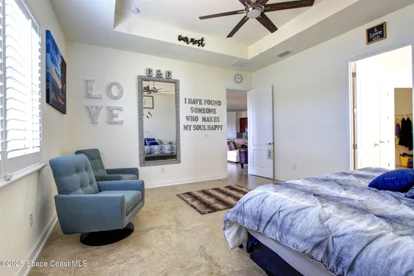 a bedroom with a bed couch and window