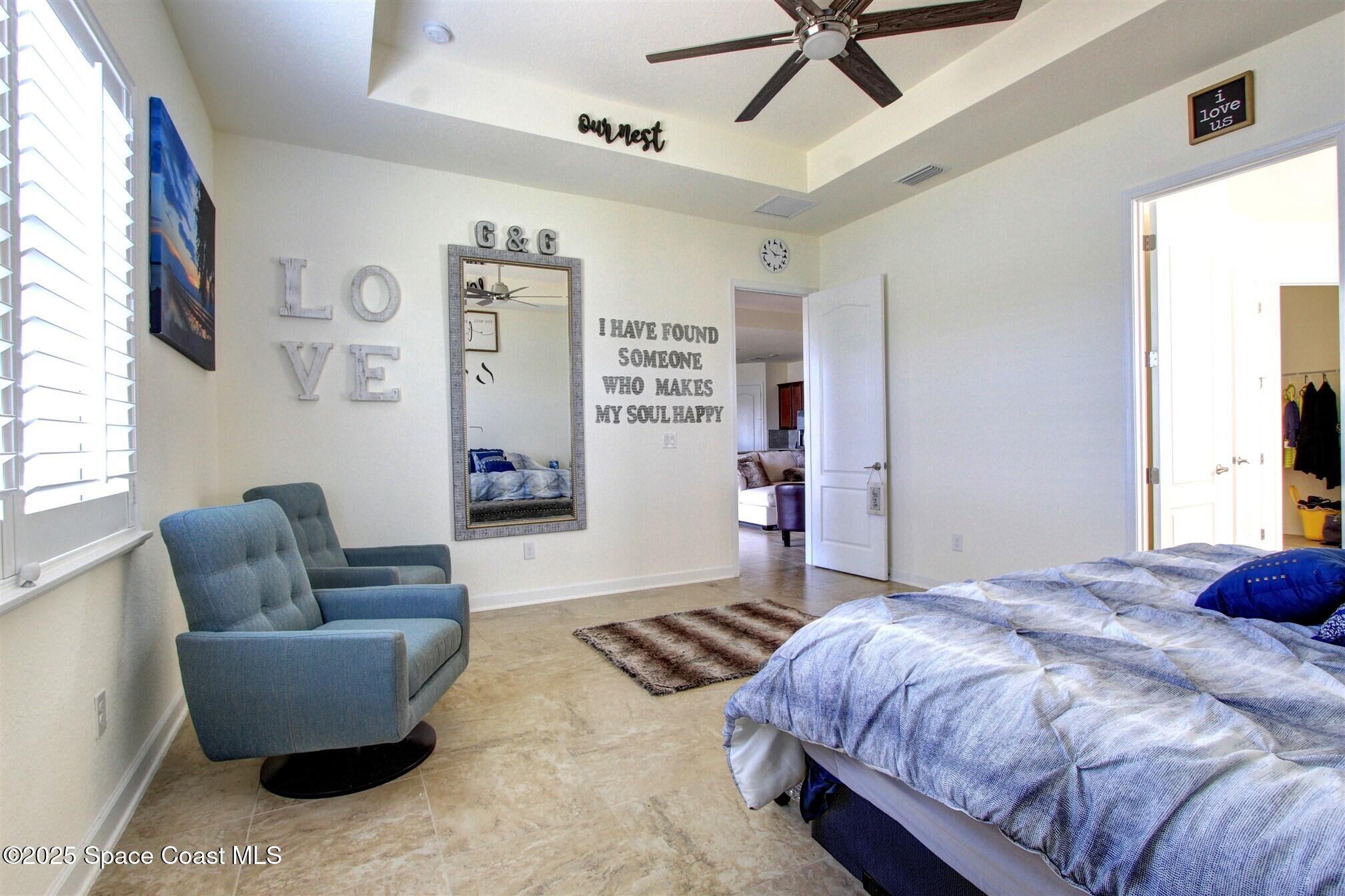 2542 Chapel Bridge Lane Melbourne, FL 32940 - Photo 23 of 44 a bedroom with a bed couch and window