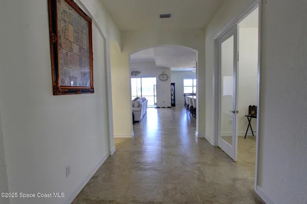 a view of a hallway with wooden floor