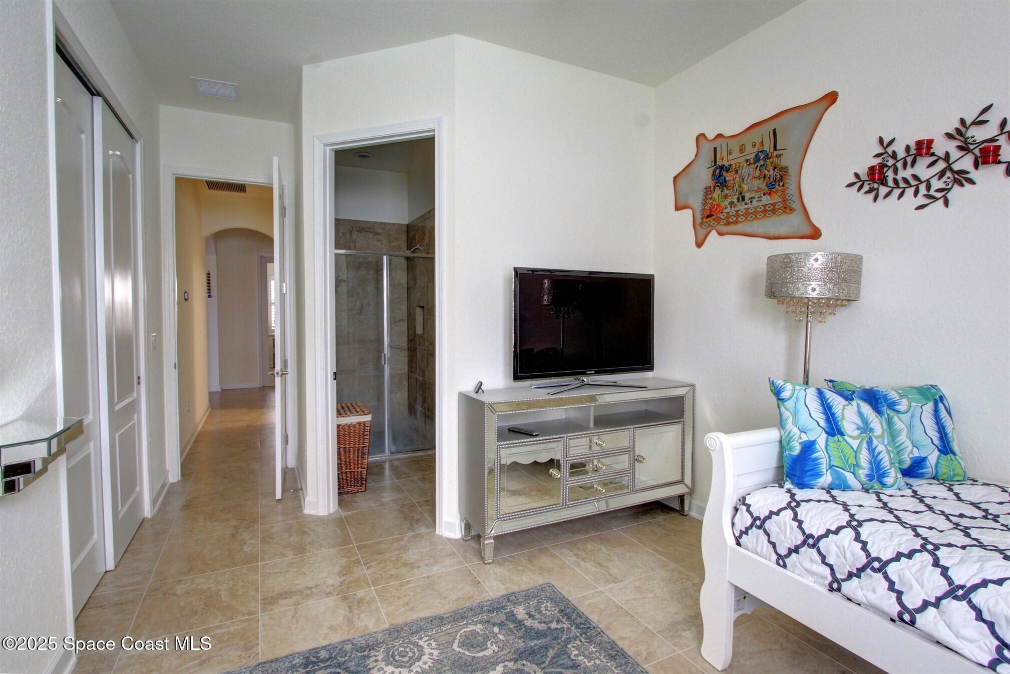 2542 Chapel Bridge Lane Melbourne, FL 32940 - Photo 30 of 44 a living room with furniture and a flat screen tv