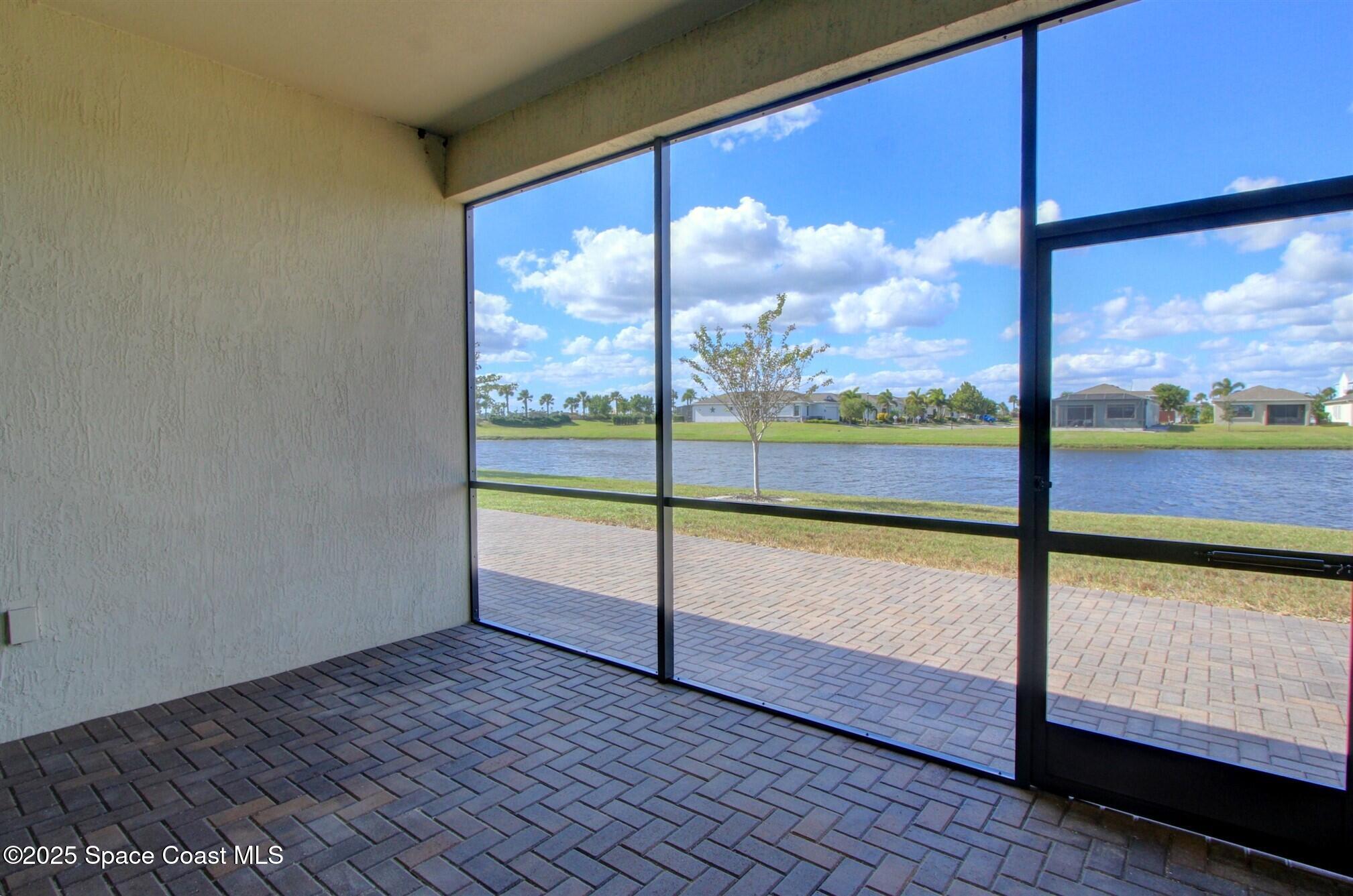 2542 Chapel Bridge Lane Melbourne, FL 32940 - Photo 32 of 44 a view of an empty room with wooden floor and windows