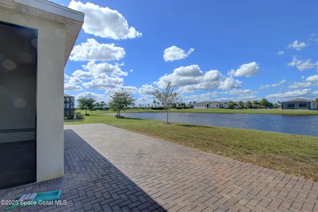 a view of a lake in the backyard of a house