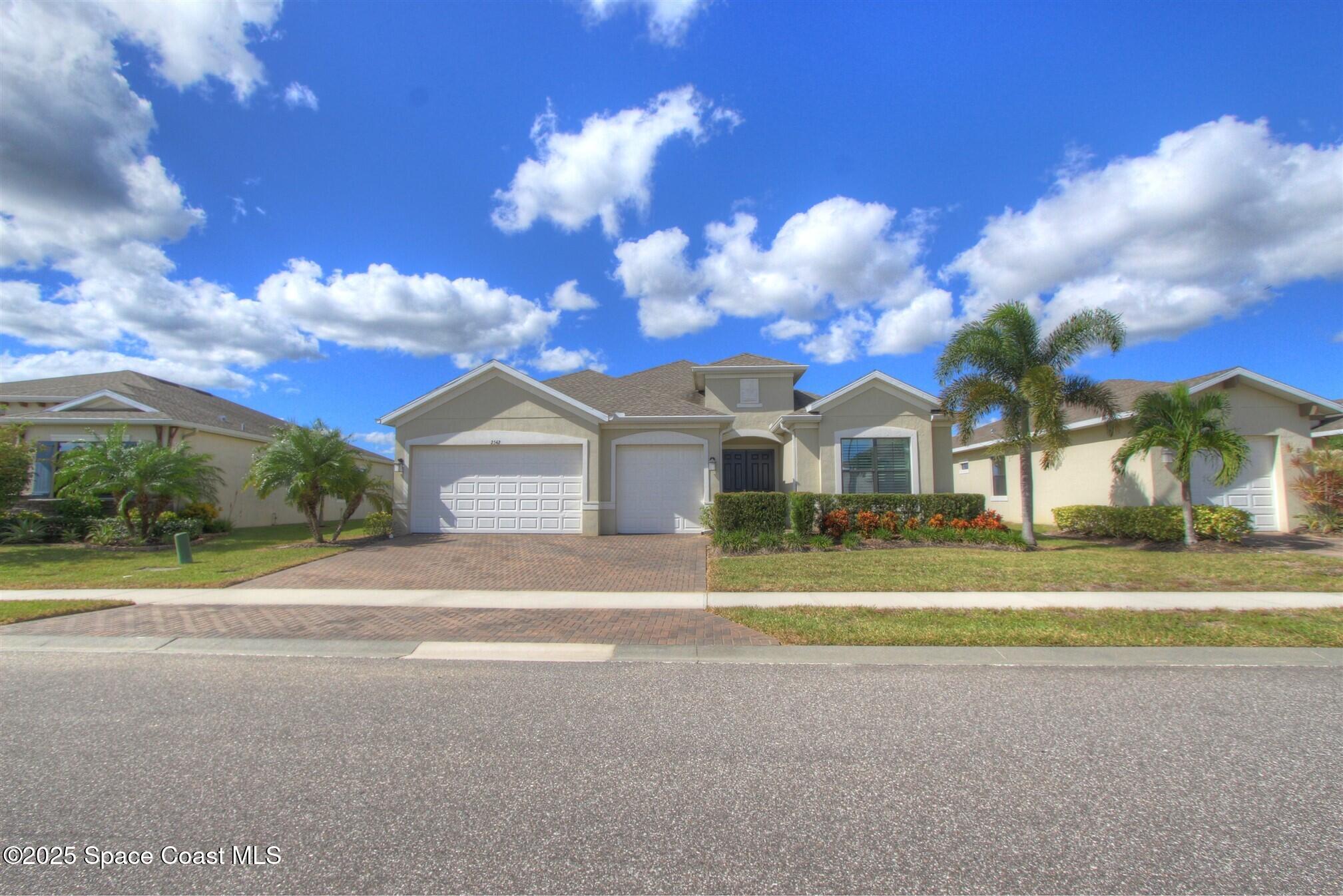 2542 Chapel Bridge Lane Melbourne, FL 32940 - Photo 40 of 44 a front view of a house with a yard and garage