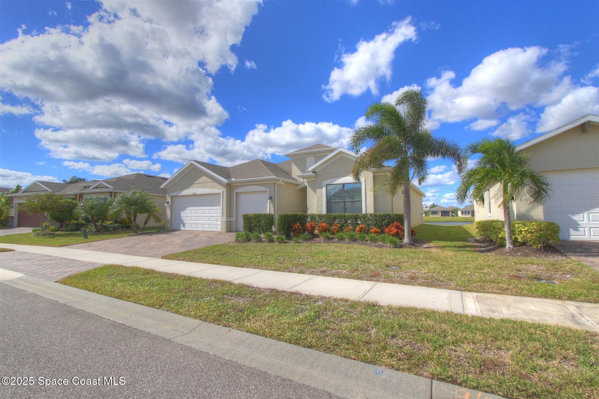 2542 Chapel Bridge Lane Melbourne, FL 32940 - Photo 41 of 44 a front view of a house with a yard and garage