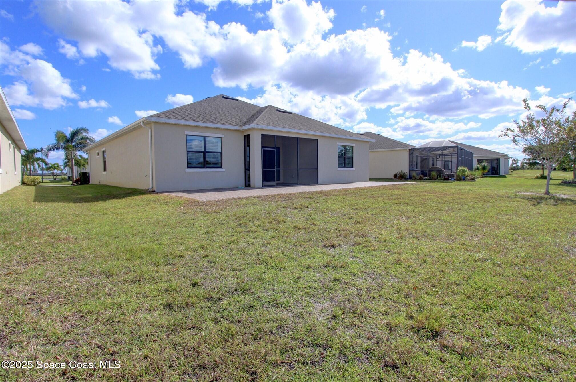 2542 Chapel Bridge Lane Melbourne, FL 32940 - Photo 43 of 44 a view of a yard in front of a house with a large tree