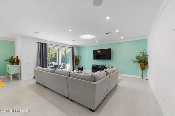 a living room with furniture and a flat screen tv