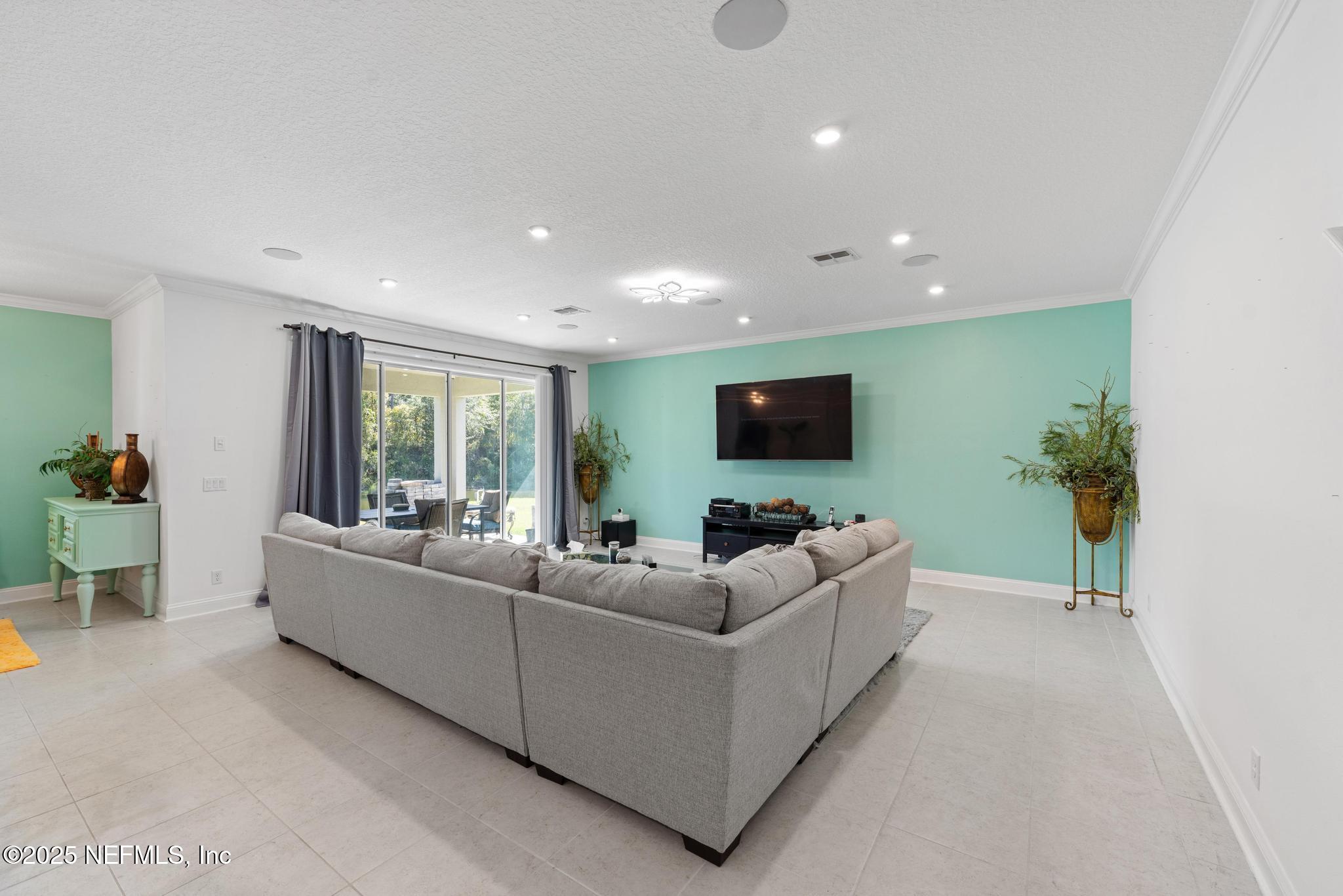 1465 Lake Foxmeadow Road Middleburg, FL 32068 - Photo 12 of 45 a living room with furniture and a flat screen tv