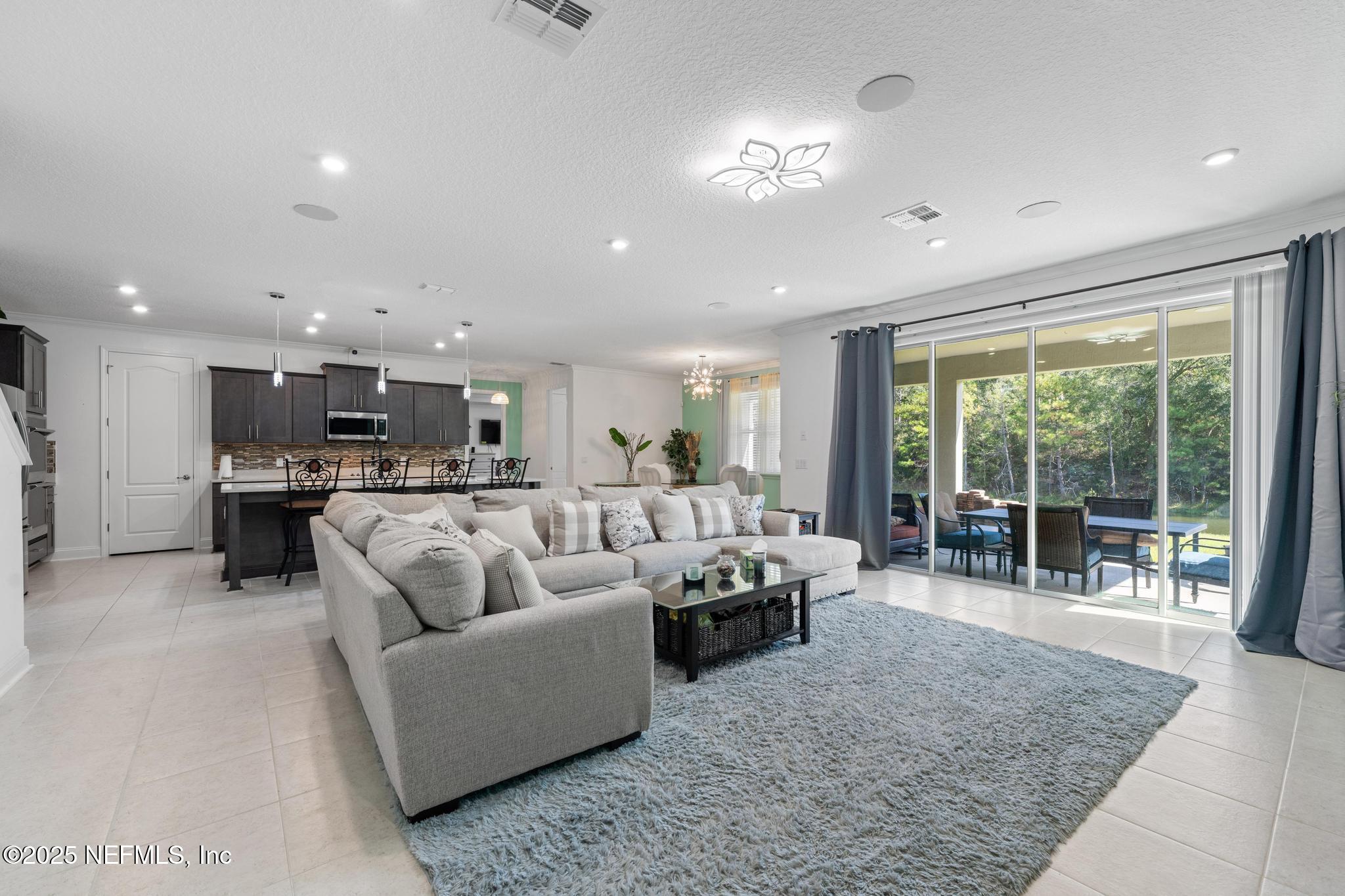1465 Lake Foxmeadow Road Middleburg, FL 32068 - Photo 13 of 45 a living room with furniture and a large window