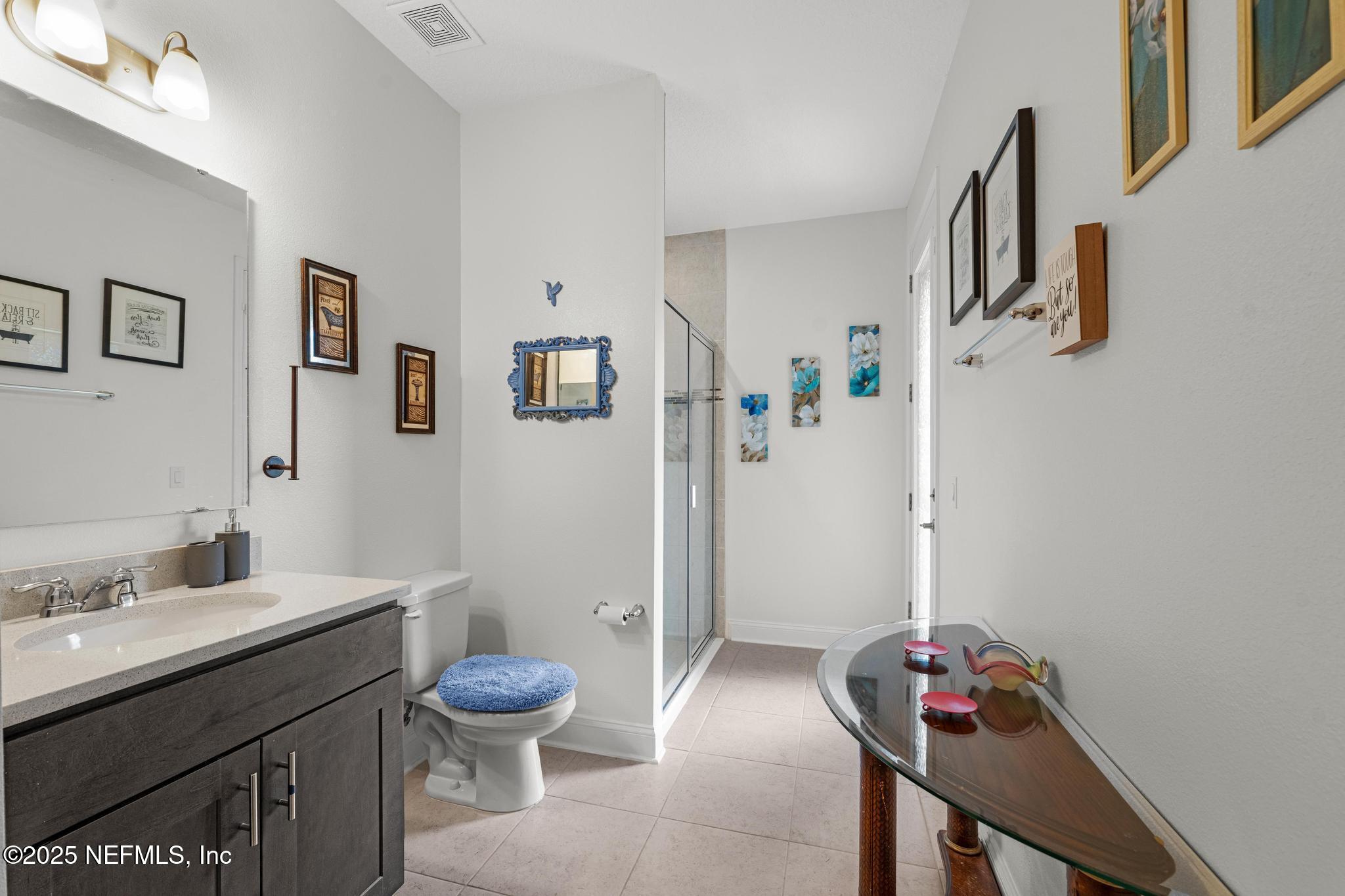 1465 Lake Foxmeadow Road Middleburg, FL 32068 - Photo 15 of 45 a bathroom with a sink toilet and shower