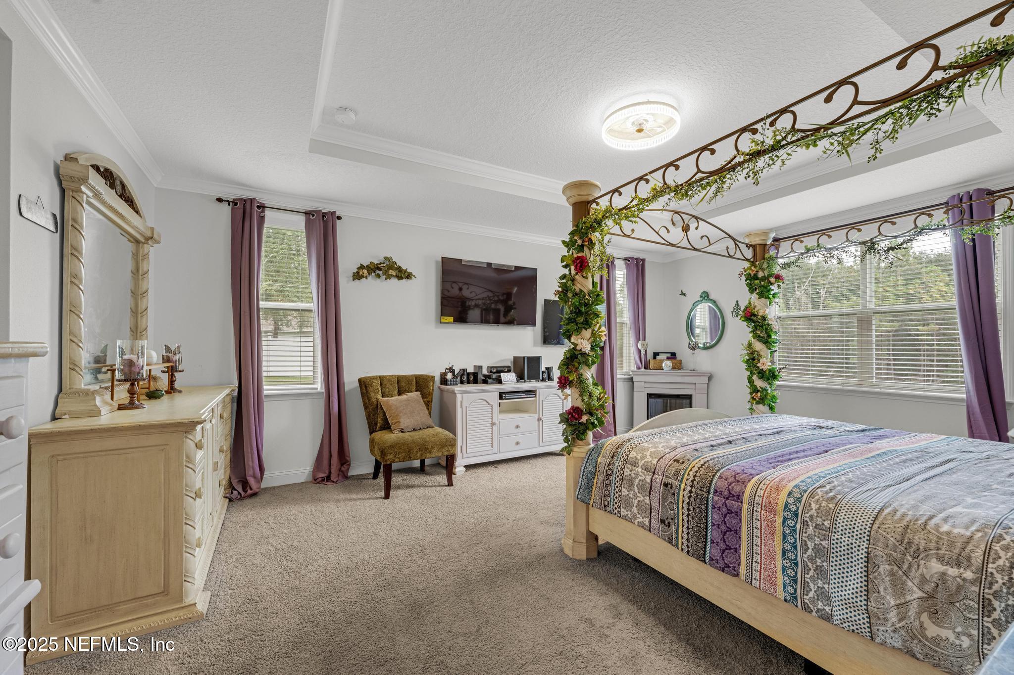 1465 Lake Foxmeadow Road Middleburg, FL 32068 - Photo 17 of 45 a bedroom with a bed couch tv and a window