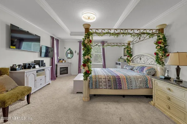 a spacious bedroom with a bed a couch and dresser