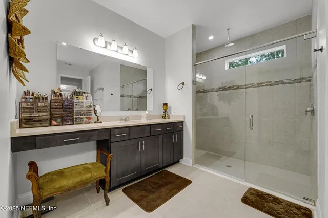 a bathroom with a sink double vanity and a shower