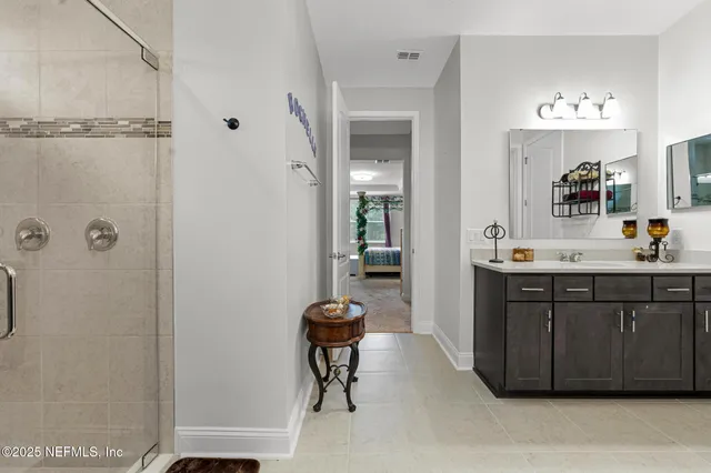 a bathroom with a sink vanity and a mirror