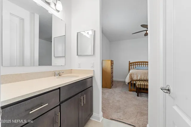 a en suite bathroom with a sink and a mirror