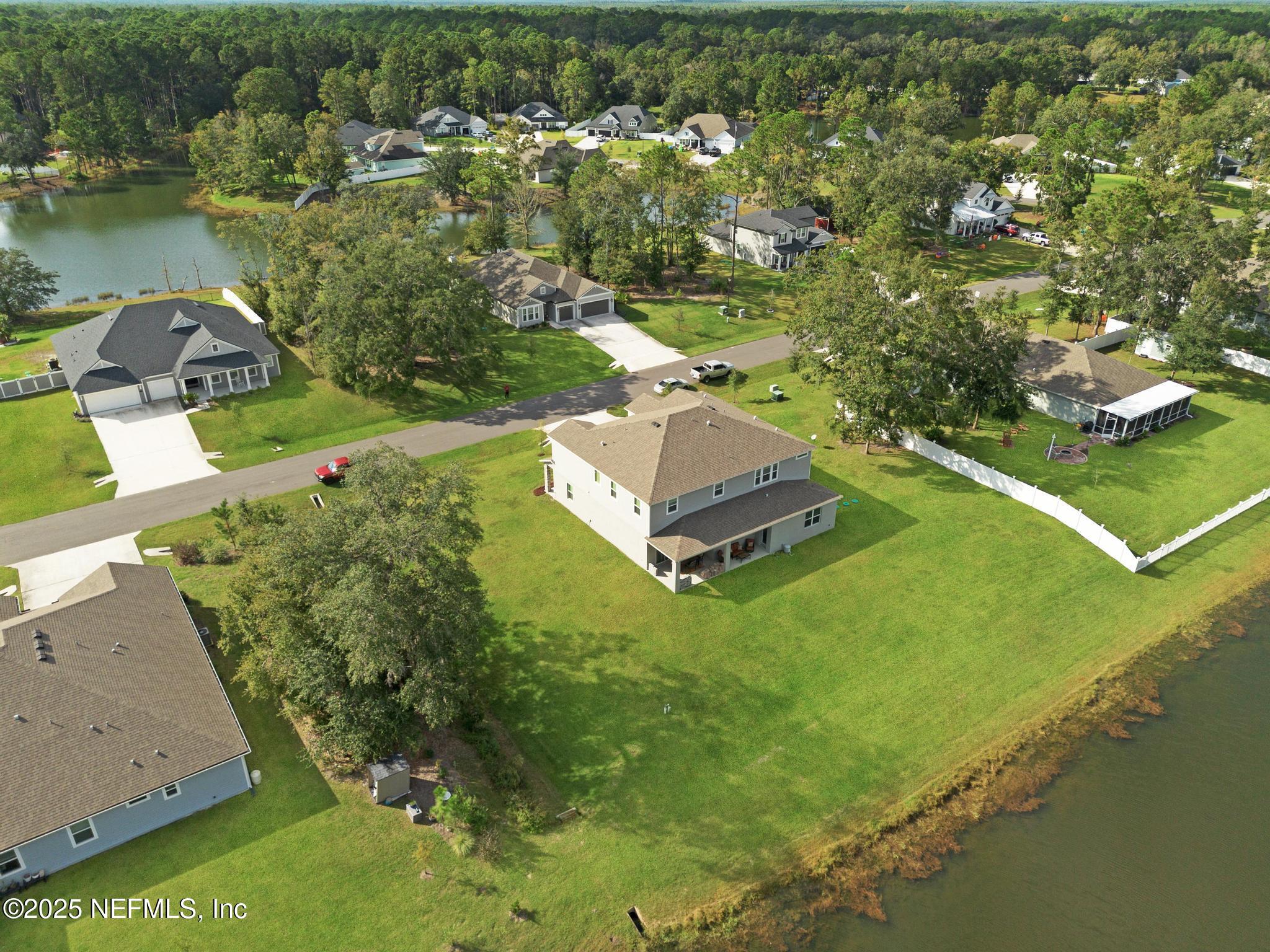 1465 Lake Foxmeadow Road Middleburg, FL 32068 - Photo 42 of 45 an aerial view of a house with a yard lake lake view and mountain view