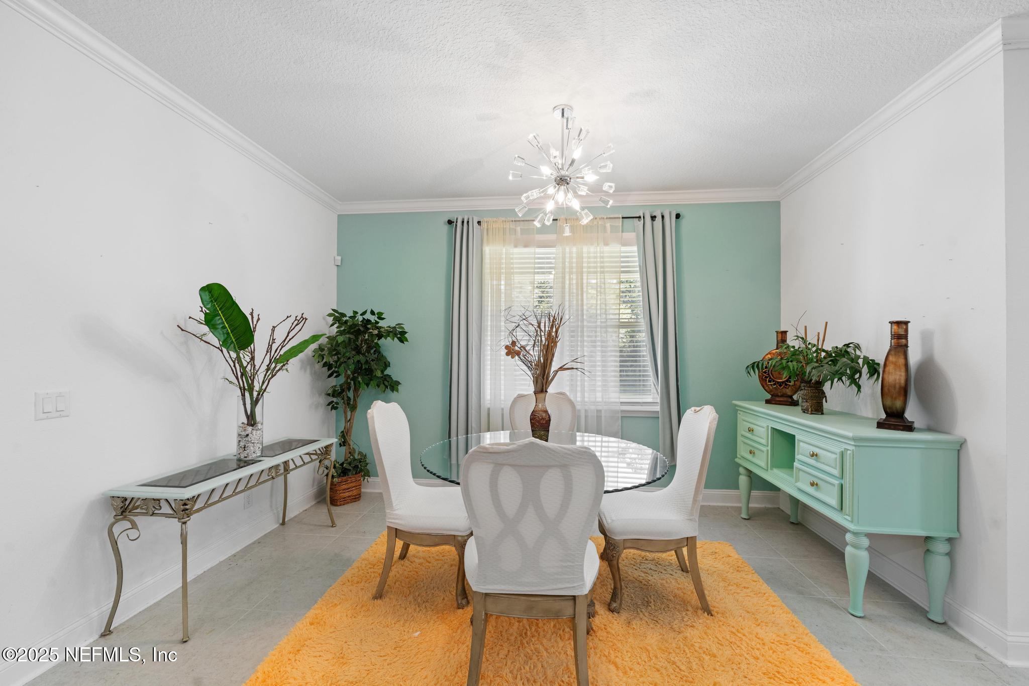 1465 Lake Foxmeadow Road Middleburg, FL 32068 - Photo 10 of 45 a view of a dining room with furniture and chandelier