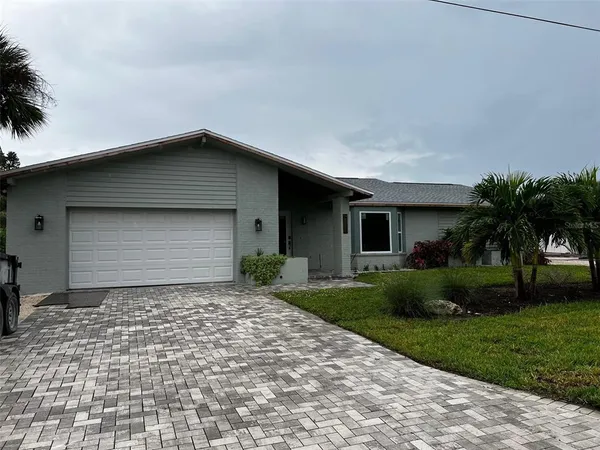 a front view of a house with a garden and yard
