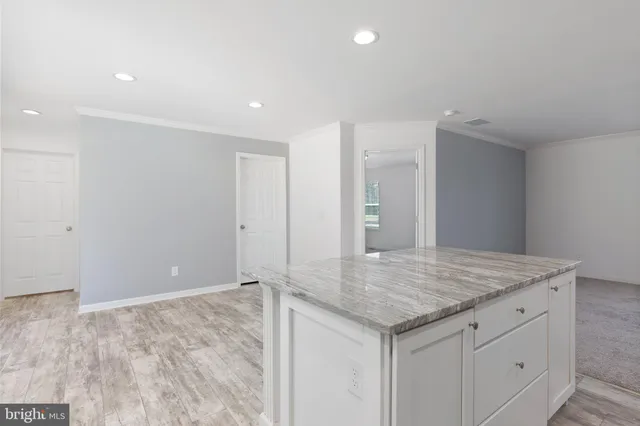 a view of kitchen cabinets and wooden floor