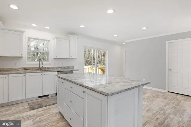 a kitchen with sink cabinets and window