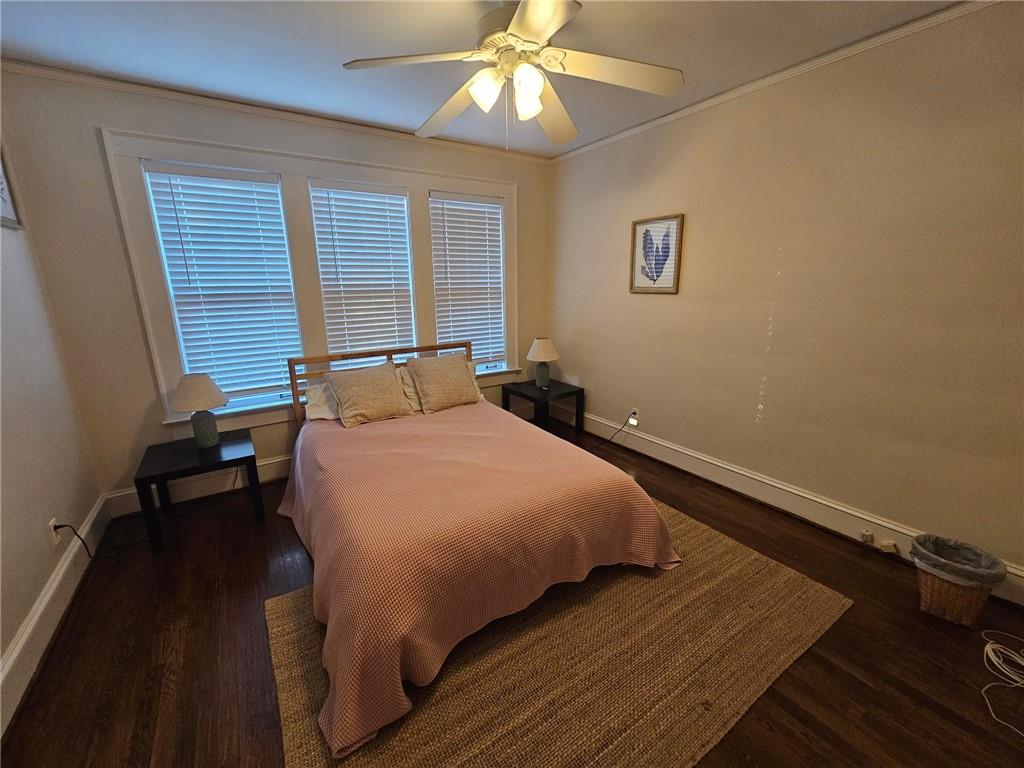 245 Lindbergh Drive Northeast Atlanta, GA 30305 - Photo 9 of 13 a bedroom with a bed and a chandelier