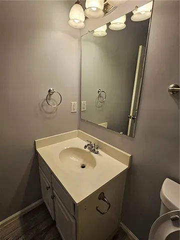 a bathroom with a sink mirror and toilet