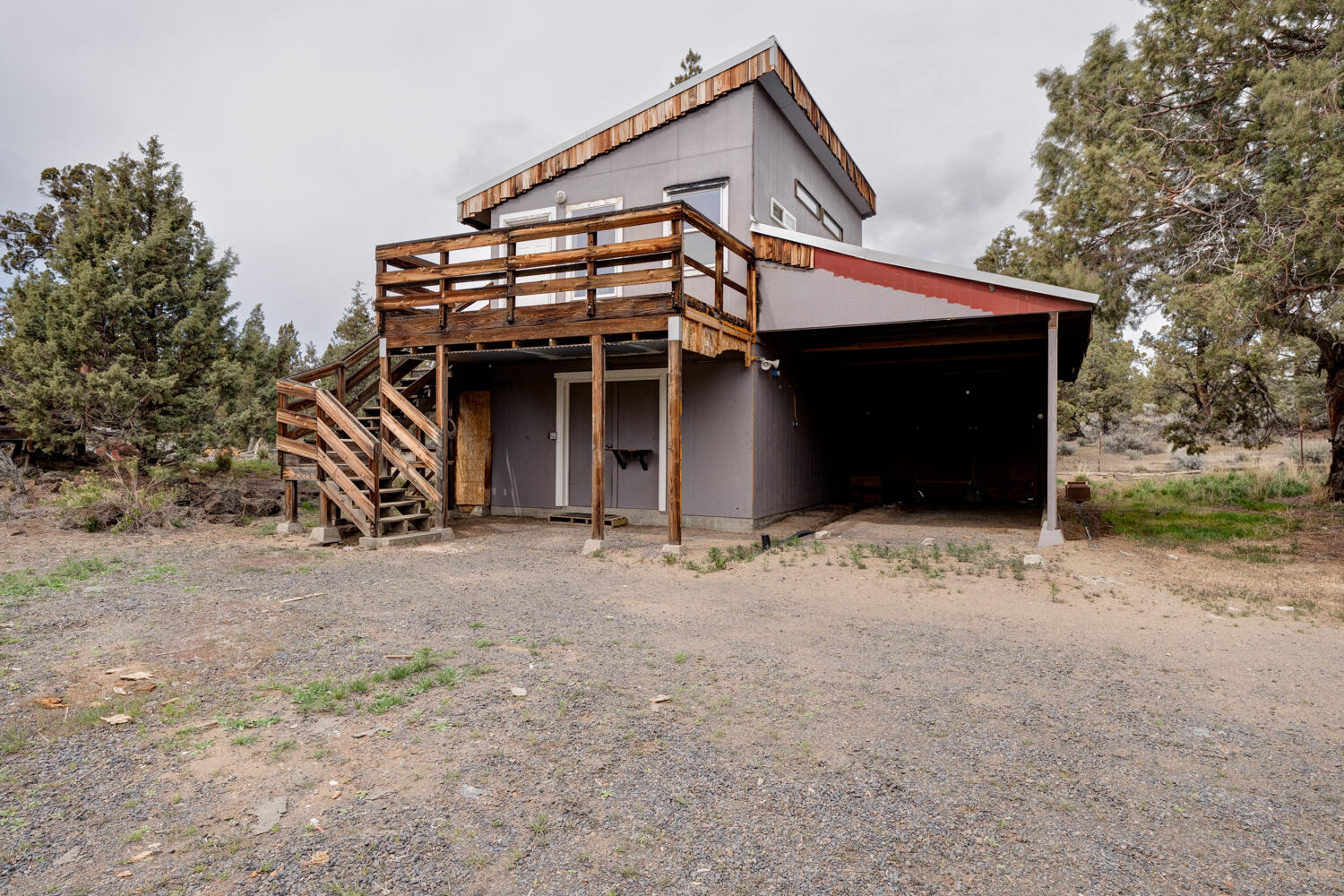64925 McGrath Road Bend, OR 97701 - Photo 41 of 51 Fully permitted building houses carport on right next to shop with concrete floor, guest suite/apartment above with private deck