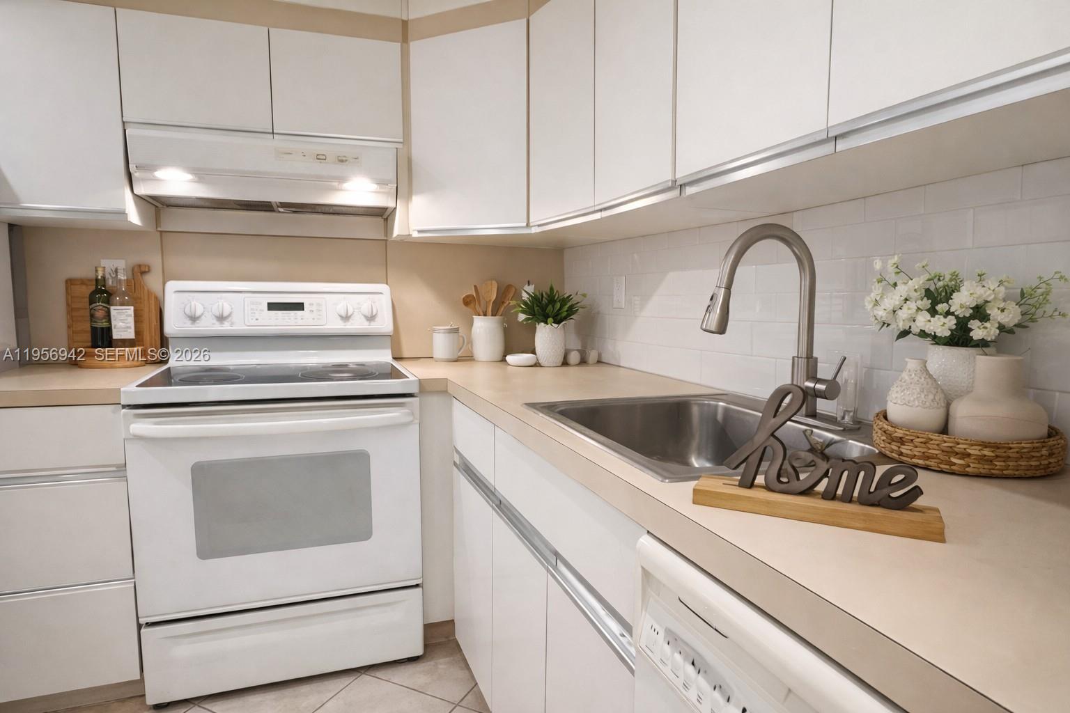 a kitchen with a stove and white cabinets