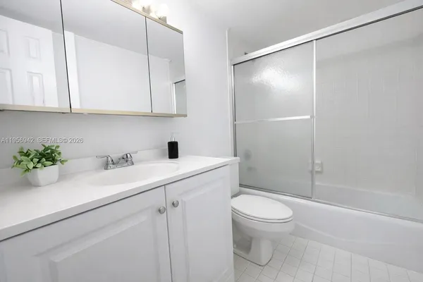 a bathroom with a sink a toilet and a shower