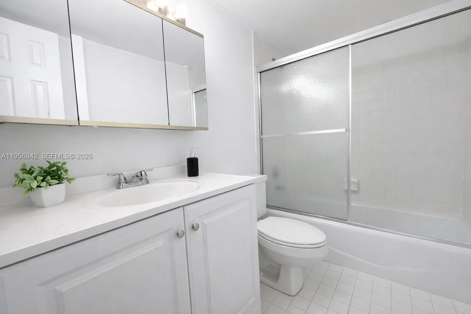 3920 Inverrary Boulevard, Unit 608C Lauderhill, FL 33319 - Photo 12 of 14 a bathroom with a sink a toilet and a shower