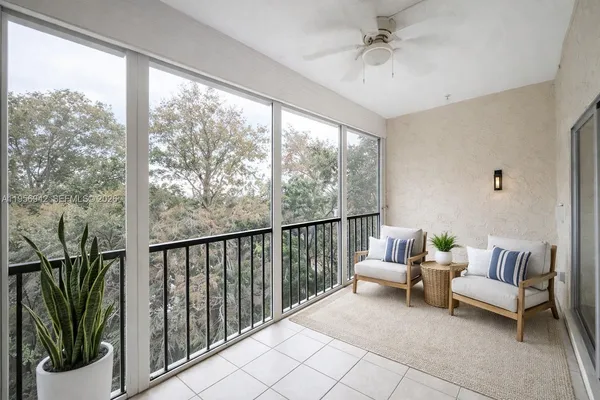 a balcony with furniture and a potted plant