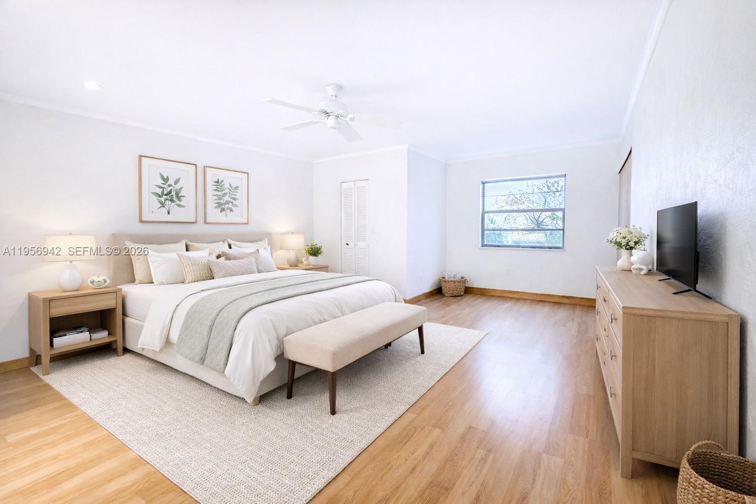 3920 Inverrary Boulevard, Unit 608C Lauderhill, FL 33319 - Photo 7 of 14 a bedroom with a bed and a flat screen tv