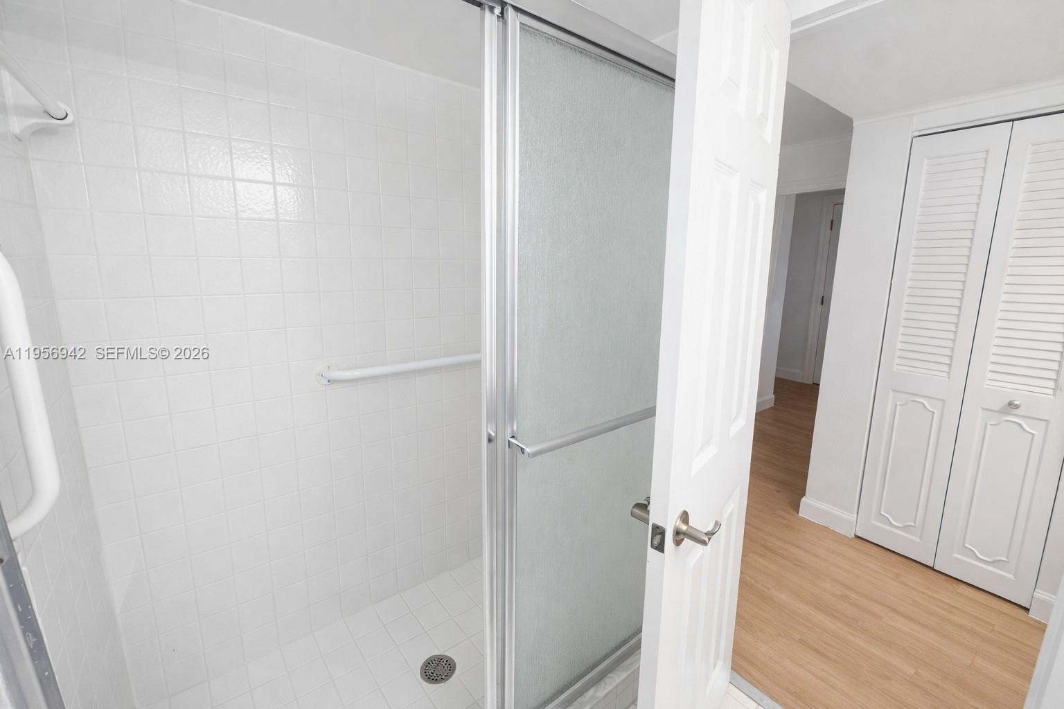 3920 Inverrary Boulevard, Unit 608C Lauderhill, FL 33319 - Photo 9 of 14 a bathroom with a glass shower door
