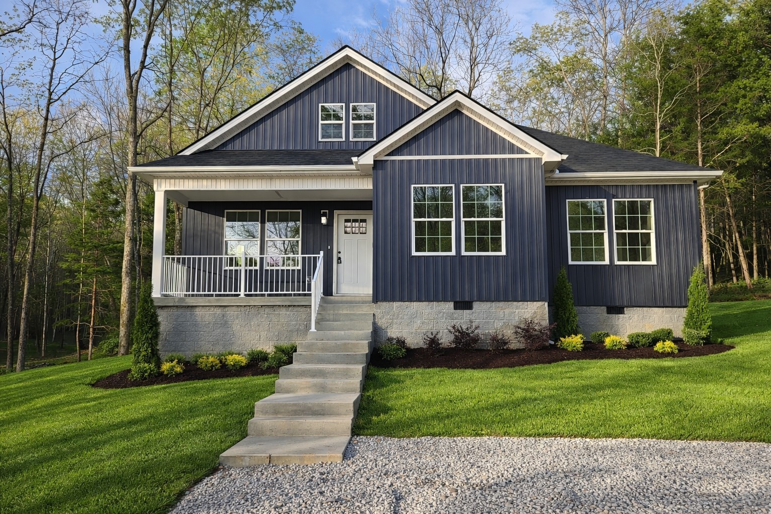a front view of a house with a yard and trees