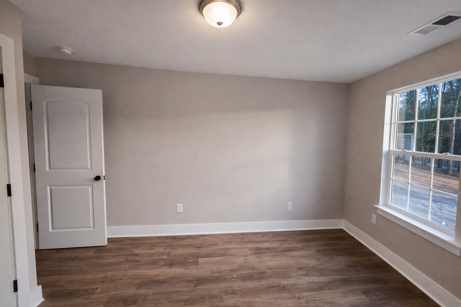 4603 Chapel Hill Road Southside, TN 37171 - Photo 18 of 25 a view of an empty room with wooden floor and a window