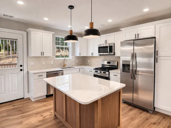 a kitchen with a refrigerator a sink and a microwave