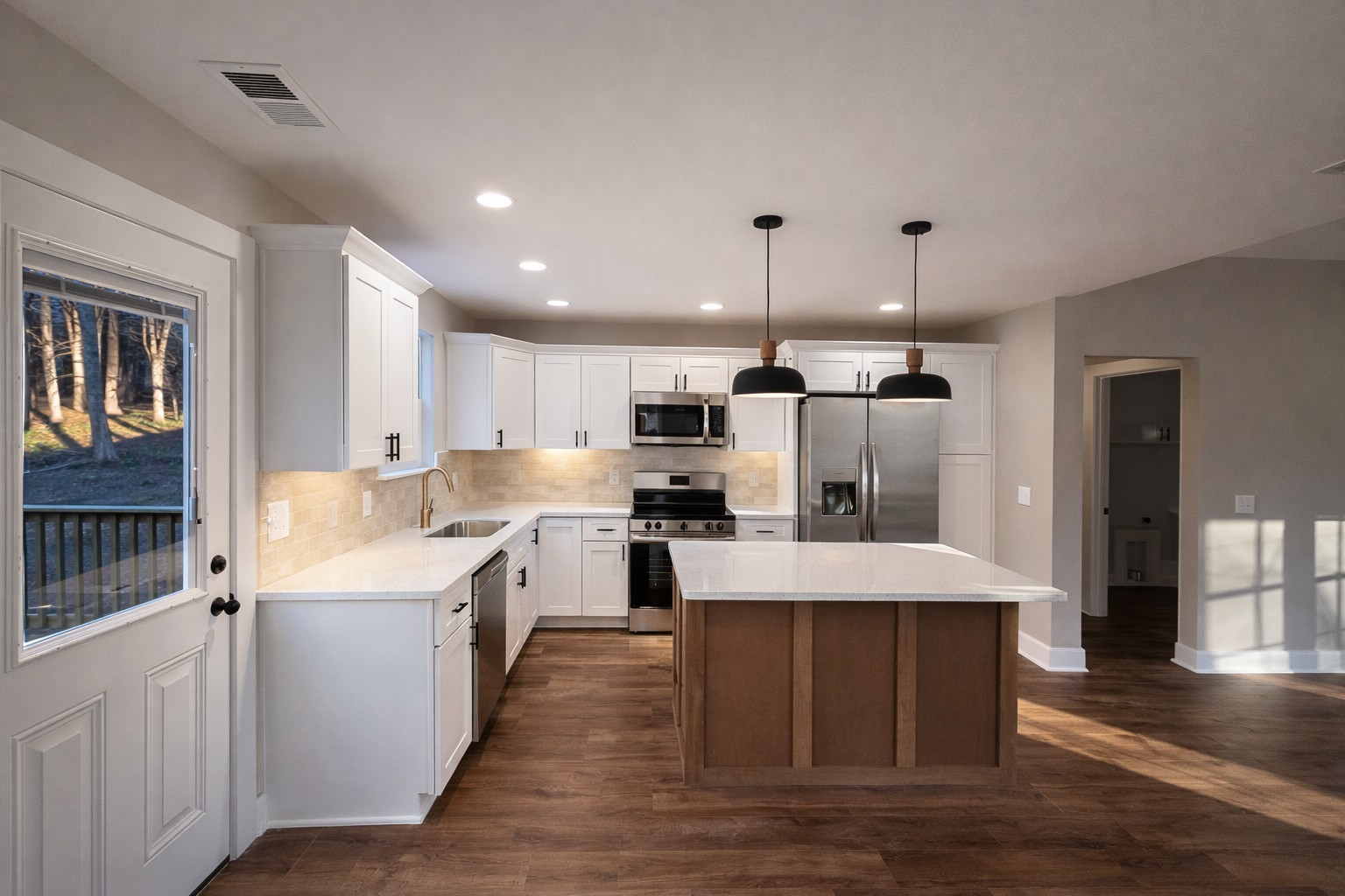 4603 Chapel Hill Road Southside, TN 37171 - Photo 10 of 25 a large kitchen with stainless steel appliances kitchen island a stove a sink dishwasher and a refrigerator with wooden floor